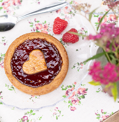 A superb raspberry Linzer Tartelette, decorated with raspberries.
